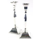 A pair of Elizabeth II silver candlesticks, each with inverted square dish holders on turned stems a