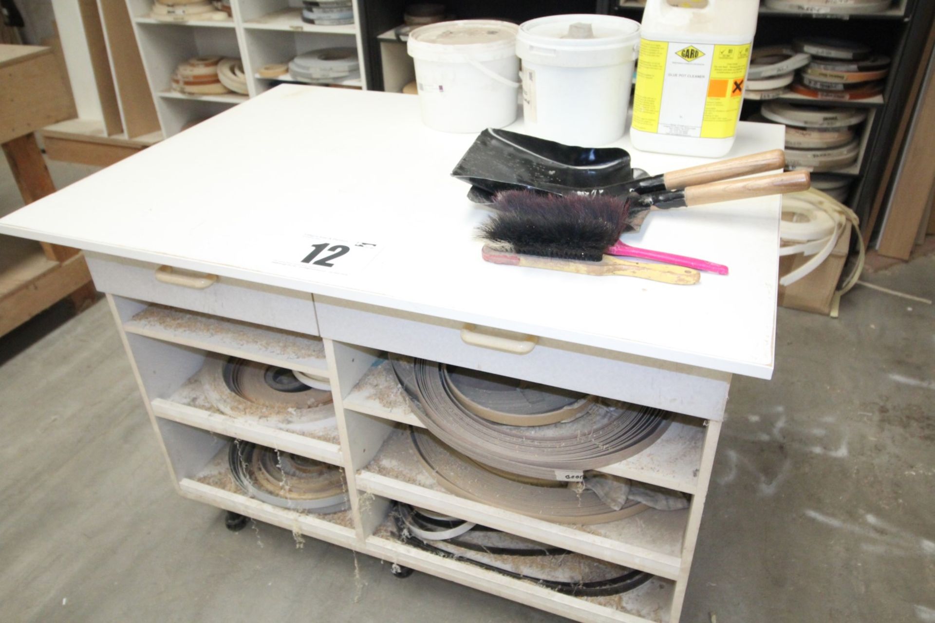 46INCH x 33INCH FREESTANDING WHITE WORKBENCH COMPLETE WITH STOCK OF MISC. EDGE BANDING