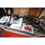 CONTENTS ON SHELF OF RACK OF MANCHESTER UNITED RELATED BROCHURES, INCLUDING 2017 V. REAL MADRID,