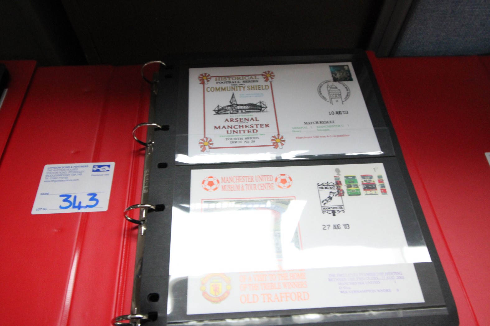 RED RING BINDER AND CONTENTS OF FIRST DAY COVER POSTCARDS ARSENAL V. MANCHESTER UNITED