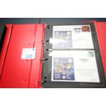 RED RING BINDER AND CONTENTS OF FIRST DAY COVER POSTCARDS MANCHESTER UNITED V. WIGAN