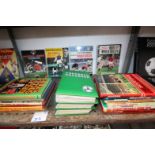 SHELF OF SPORTS BOOKS INCLUDING FOOTBALL HANDBOOK, AND BOOK OF WORLD SOCCER