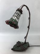 Tiffany style table lamp with a dragonfly and leaf base