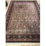 Rose ground carpet with blue borders, approx 310cm x 200cm