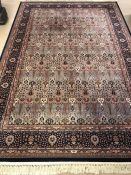 Rose ground carpet with blue borders, approx 310cm x 200cm