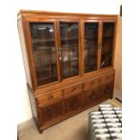 Imported Chinese rosewood sideboard with glass cupboards and shelving over, Chinese carved detailing