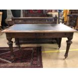 Antique writing desk with black leather top with fluted legs, brass castors and two drawers under