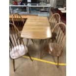 Blonde Ercol Dining table and four stick back chairs