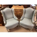Pair of green upholstered wingback armchairs