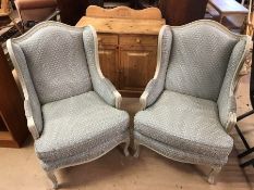 Pair of green upholstered wingback armchairs