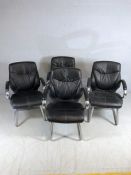 Set of four heavily upholstered black and chrome chairs