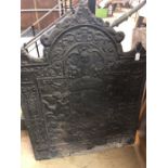 Large antique fire back depicting cherubs holding a heraldic shield, height approx 108cm, width