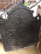 Large antique fire back depicting cherubs holding a heraldic shield, height approx 108cm, width