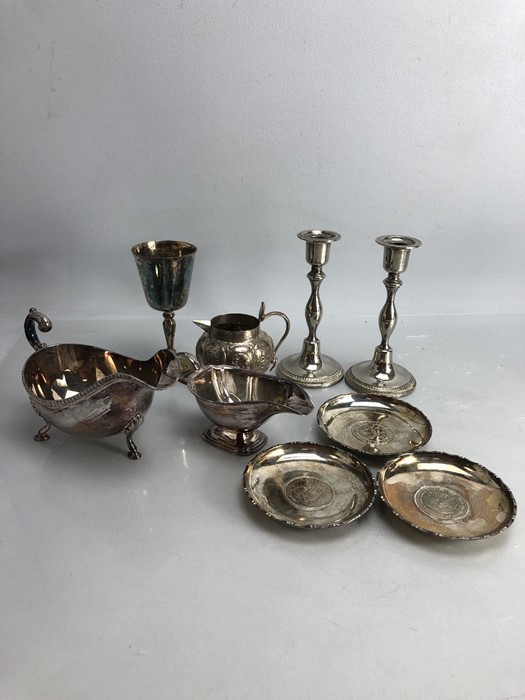 Collection of Silver plated items to include a pair of candlesticks, sauce boats, pin dishes etc...