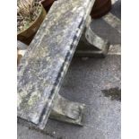 Two pedestal well-weathered garden bench