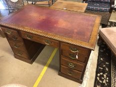 Knee hole desk with four drawers per pedestal and central drawer all with ornate brass handles and