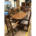Oak oval modern extending dining table with six matching upholstered chairs