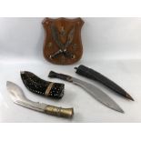 Two kukri/ khukuri machetes originating from the Indian subcontinent, traditionally associated