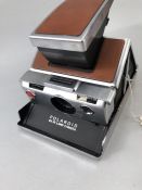 VINTAGE POLAROID SX-70 LAND CAMERA with tan leather coverings