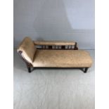 Victorian chaise lounge with turned feet and carved decoration to rear panel