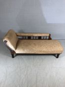 Victorian chaise lounge with turned feet and carved decoration to rear panel