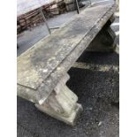 Two pedestal well weathered garden bench
