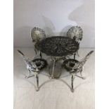 Cast iron circular garden table and four chairs