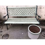 Garden Bench with Wrought iron ends and back painted in green with a similar coloured Garden pot
