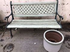 Garden Bench with Wrought iron ends and back painted in green with a similar coloured Garden pot