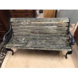 Garden bench with wrought iron ends with lion detailing and wooden slats