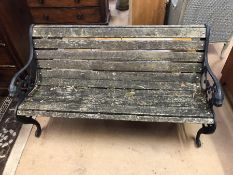 Garden bench with wrought iron ends with lion detailing and wooden slats
