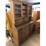 Large pine dresser with two glazed cupboards and shelves over, three drawers and cupboards under,