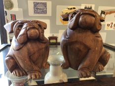 Pair of carved wooden bulldogs, the larger approx 20cm tall