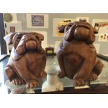 Pair of carved wooden bulldogs, the larger approx 20cm tall