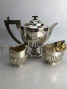 Silver hallmarked three piece tea set to include a large teapot (approx 702g) milk jug (approx 103g)