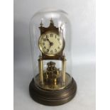 A brass 400-day clock, marked BHA, under glass dome, 29cm high overall