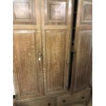 Oak triple wardrobe with two drawers under by R.H. Whittle & Sons