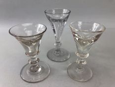 Three late 18th century squat ale or cordial glasses with clear tapering bowls and snapped pontils