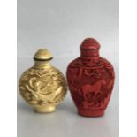 Chinese Cinnabar snuff bottle with stopper (markings to base, approx 7.5cm tall) and a second