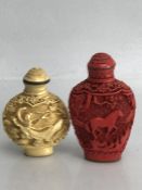 Chinese Cinnabar snuff bottle with stopper (markings to base, approx 7.5cm tall) and a second