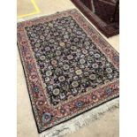 Blue ground woollen rug with pink border and floral design. Approx 185cms x 122cms