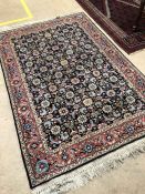 Blue ground woollen rug with pink border and floral design. Approx 185cms x 122cms