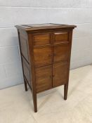 Polished wood drinks cabinet raised on legs with opening top and cupboard under (A/F), approx 47cm x