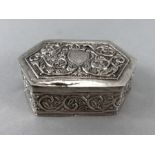 Unmarked Silver repousse decorated pill box with blank cartouche