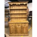 Pine dresser with three cupboards and drawers under and three shelves over, approx 208cm tall x