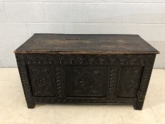 18th Century heavily carved three panel oak coffer with three plank lid, approx 107cm x 45cm x