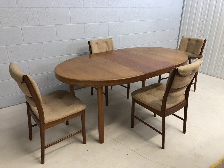 Mid Century oval extending dining table with four chairs (one carver). Approx dimensions fully