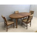 Mid Century oval extending dining table with four chairs (one carver). Approx dimensions fully