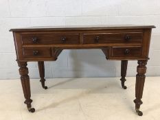Writing desk by Edwards & Roberts with four drawers, raised on fluted legs with castors, approx