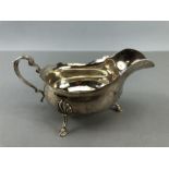 Silver hallmarked sauce boat on three feet (15cm long)